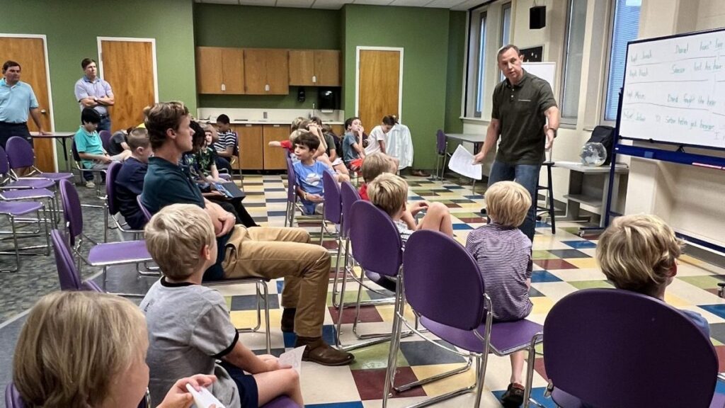 Royal Ambassadors at FBC Montgomery sit in classroom chairs engaging in the God at Work curriculum